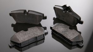 Set of brake pads on a mirror background