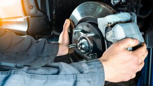 A mechanic installing new brakes.